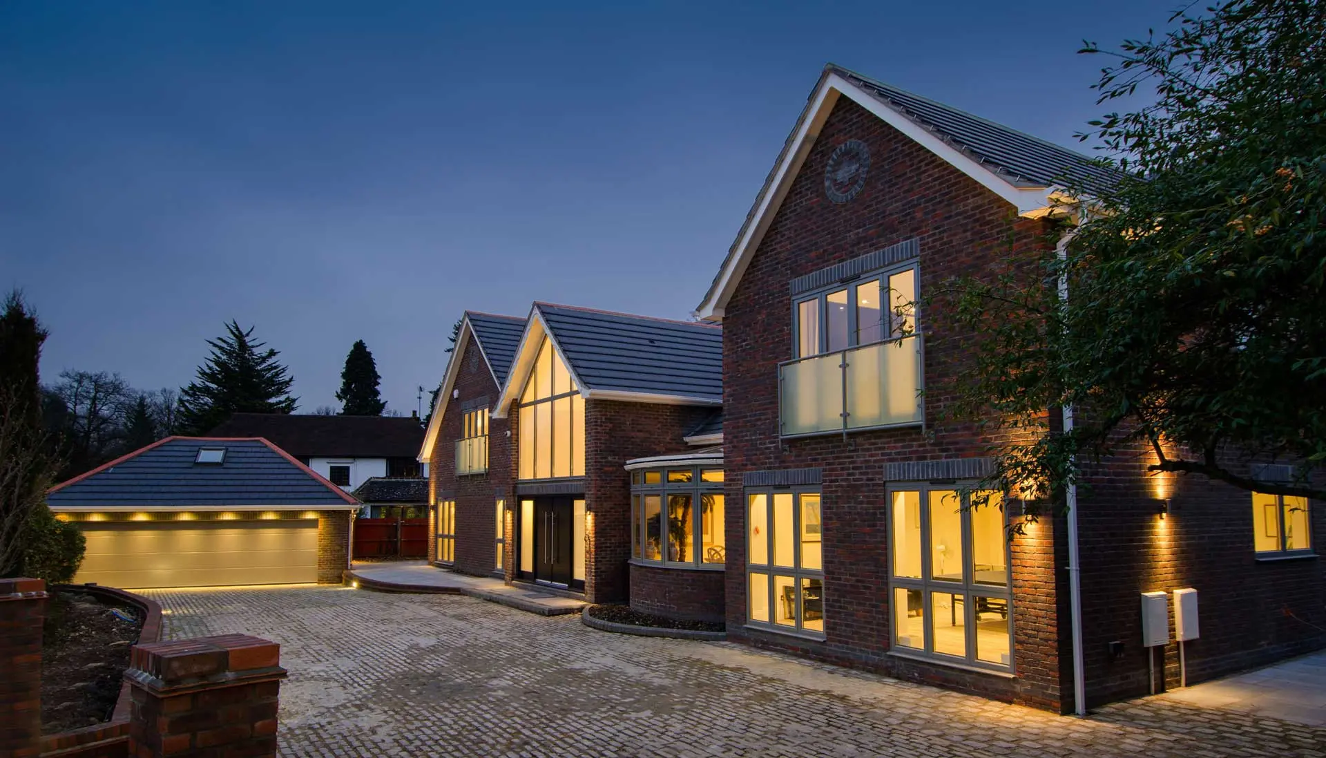 Modern homes at dusk with large aluminium windows and doors (partner photograph)