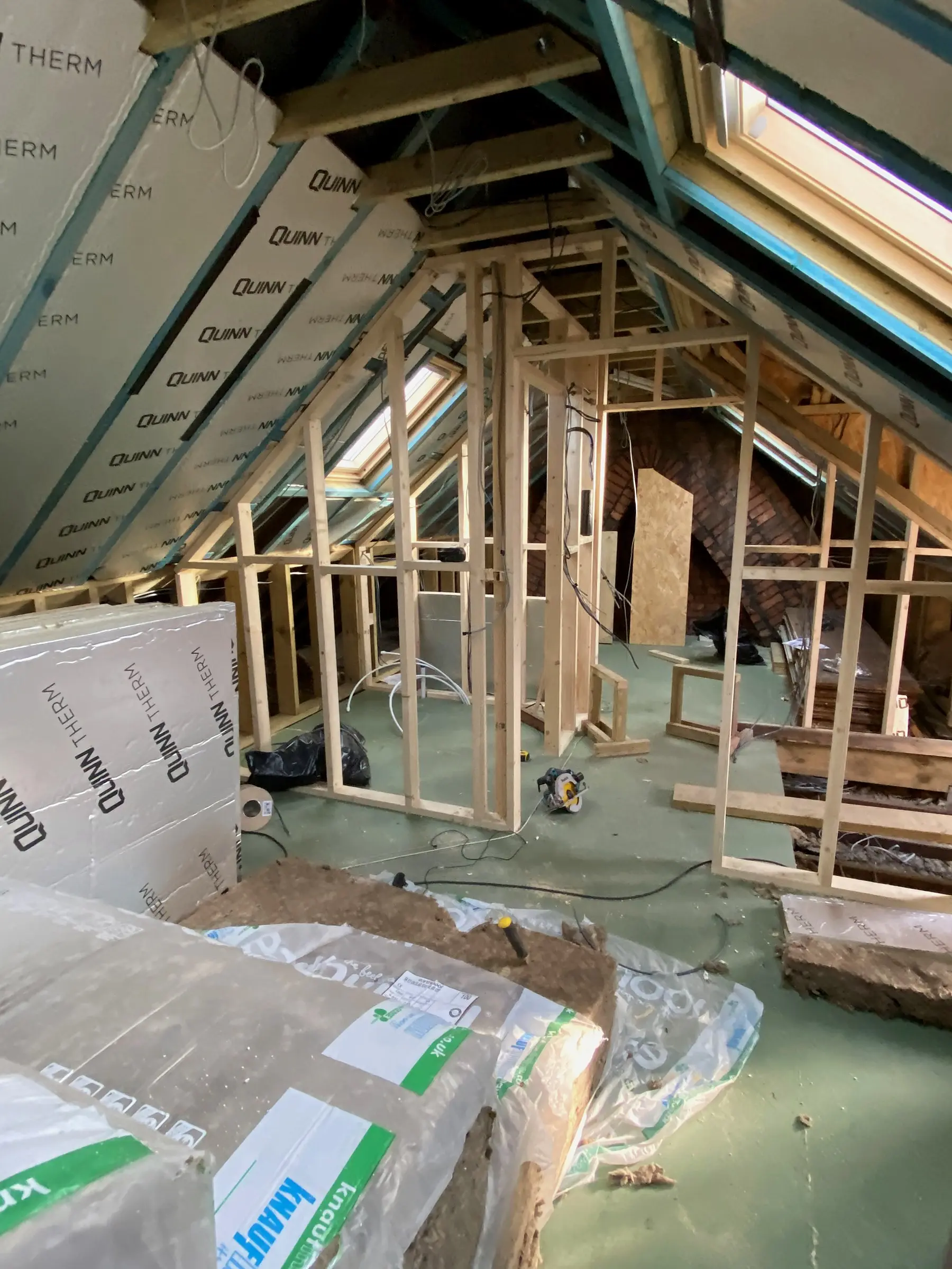 Loft conversion at first fix: new rafters, insulation boards and a Velux window